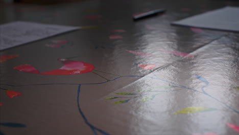 money falling from above onto a table, pushed across by a man wearing a wedding ring