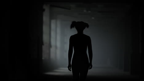 Female-athlete-walking-in-corridor.-Sporty-woman-going-in-dark-loft-building