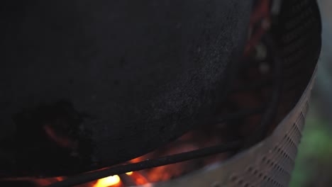 Glowing-Embers-in-a-Dark-Metal-Fire-Pit