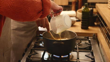 woman cooking soup in the kitchen