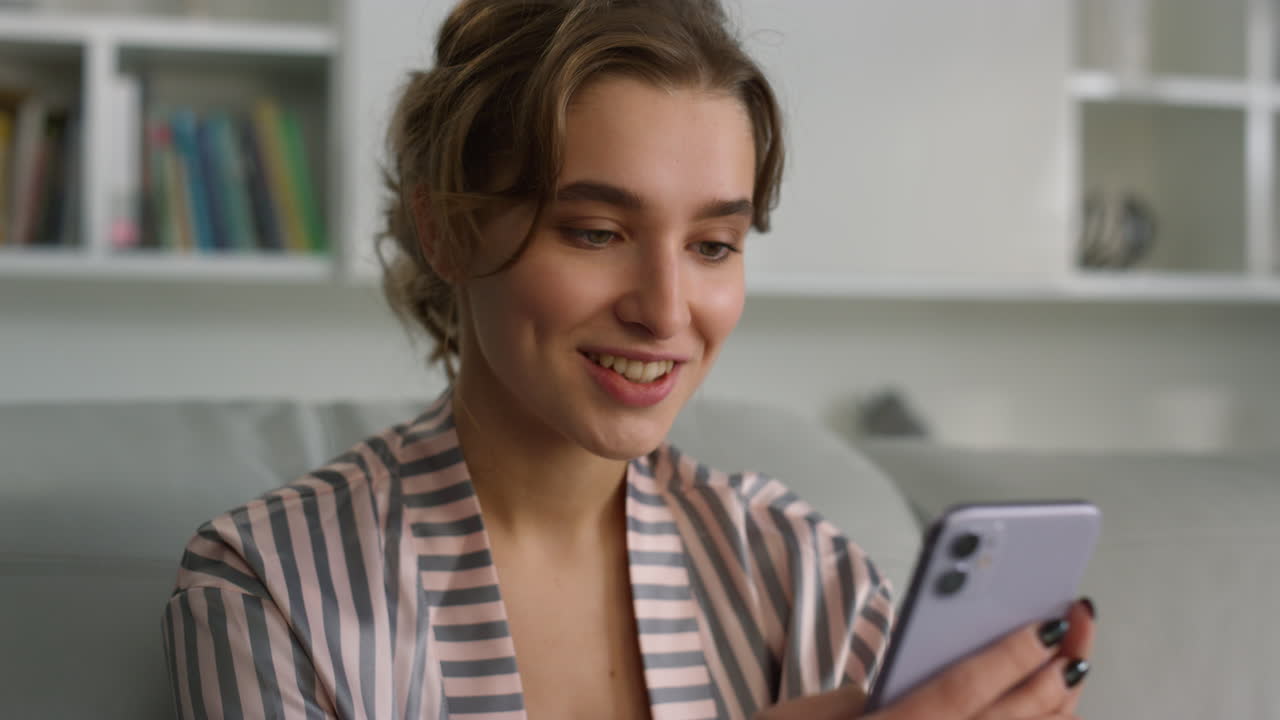 Smiling student enjoy watching video blog at home closeup. Focused app customer