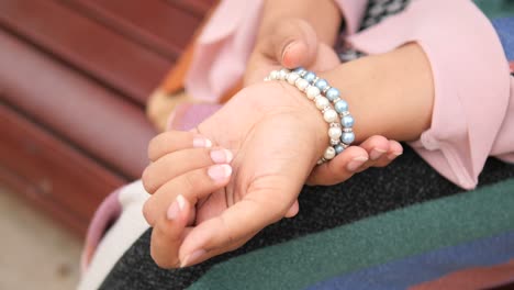 woman wearing pearl bracelet