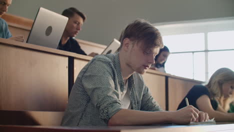 the college current audience in which students listen to the teacher and write a short film report in the notebook. transfer knowledge and educate students.