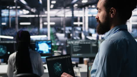close up of developer in data center coding with generative ai on laptop