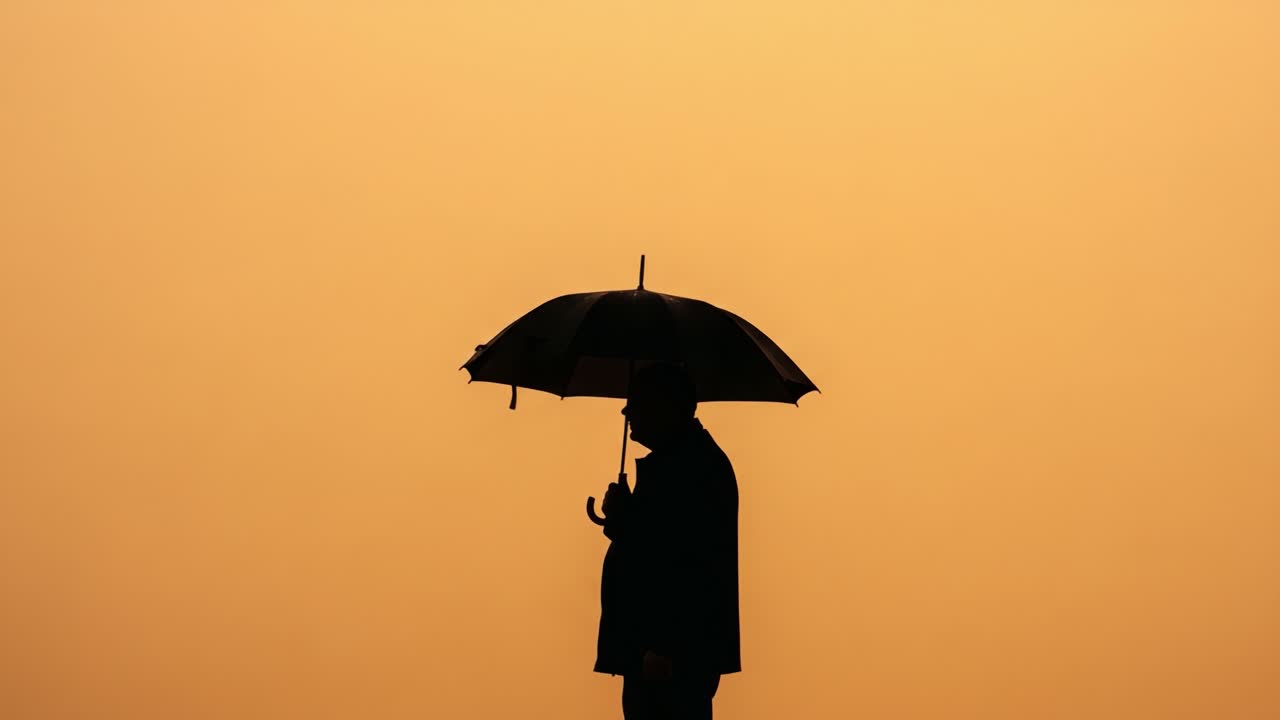 A solitary figure stands against a serene golden sunset, holding an umbrella, capturing the essence of stillness and contemplation in a tranquil atmosphere