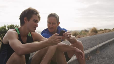 father and young adult son enjoying outdoor activities together