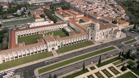 Astounding-View-Of-Jeronimos-Monastery-In-Front-Of-The-Garden-Of-Imperio-Square-In-Belem-Neighborhood,-Lisbon,-Portugal