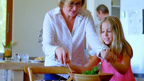 family preparing salad in kitchen 4k