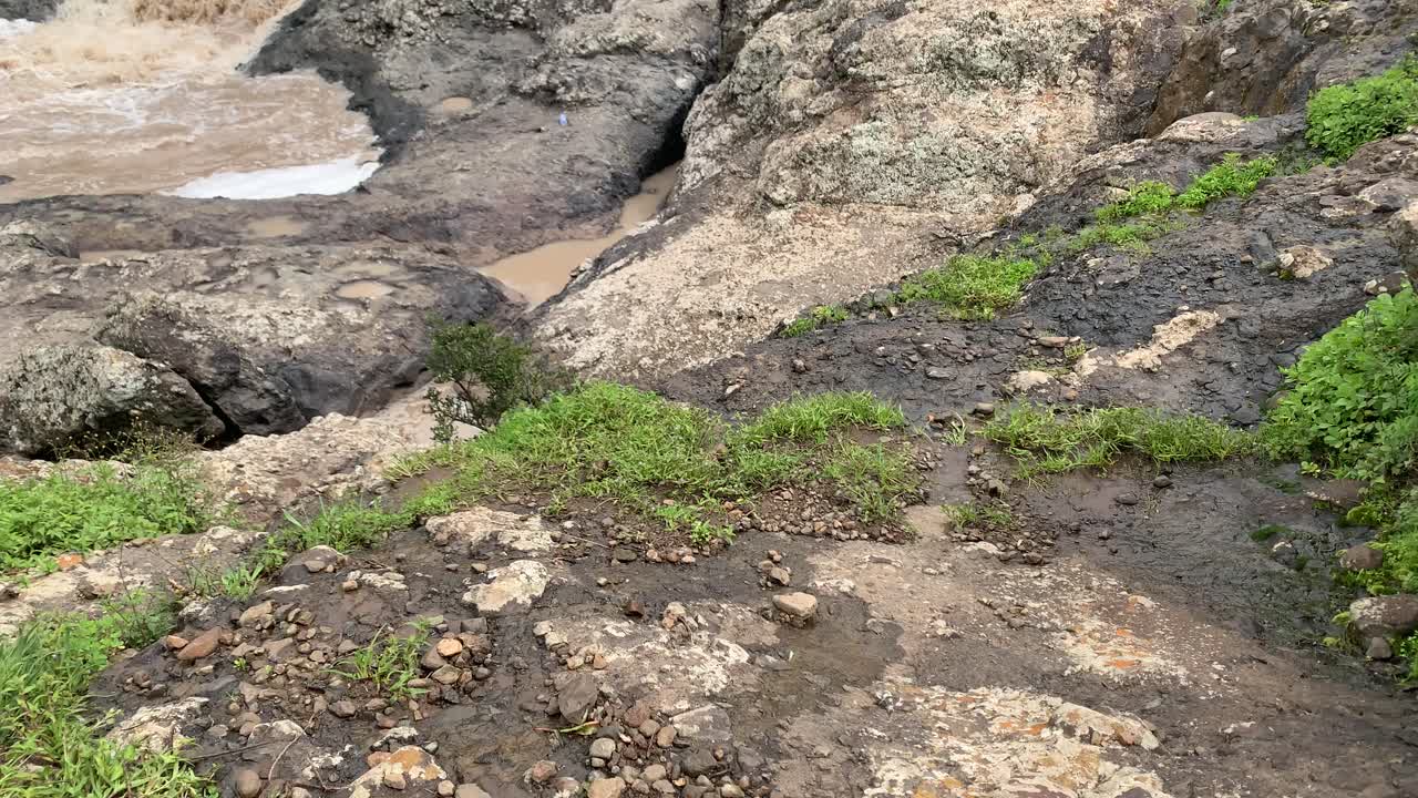 Pan up for the Debre Libanos, Debre Birhan waterfall bridge while the hikers setting and enjoying the view.