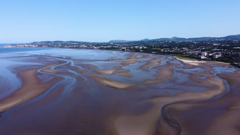 fly-by over sandymount beach, dublin, ireland during a low tide