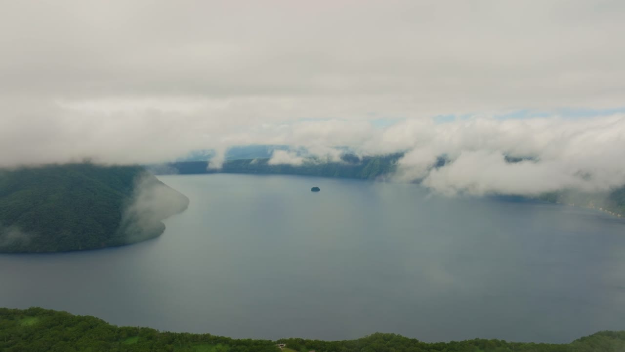 Aerial Natural landscape of Lake Mashu's Pristine Waters, cloudy skyline of Hokkaido Japan, Ainu environment