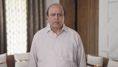 uninterested old indian man listening to someone