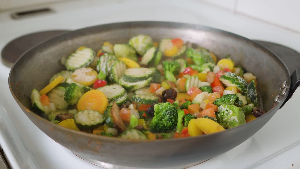 Mix of frozen vegetables in a frying pan
