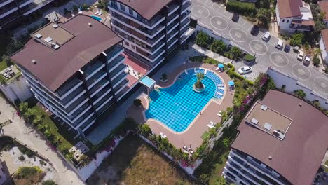 aerial view of modern apartments complex with swimming pool