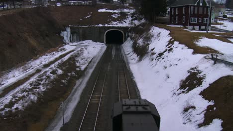 high angle over a freight train going through a tunnel