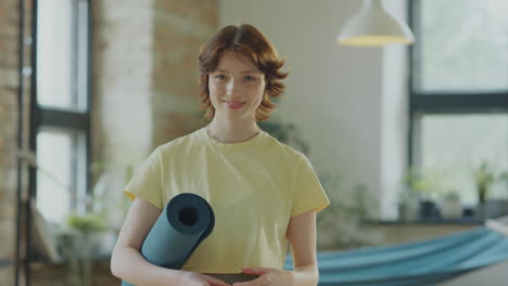 portrait of girl with yoga mat