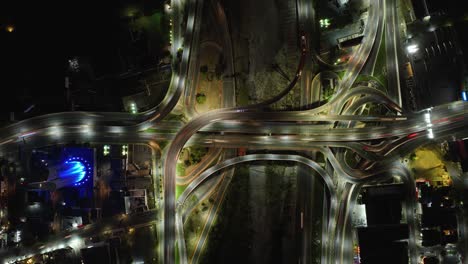 hyperlapse aerial above traffic in a illuminated junction, evening in mexico - cenital, drone shot