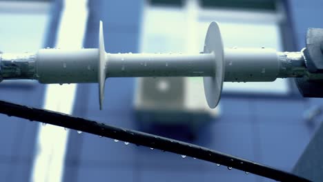 close-up view of electrical equipment on a building, during rain