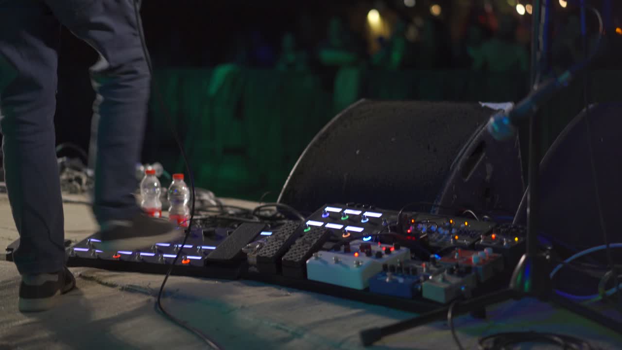 Guitar player using pedals live on stage music show