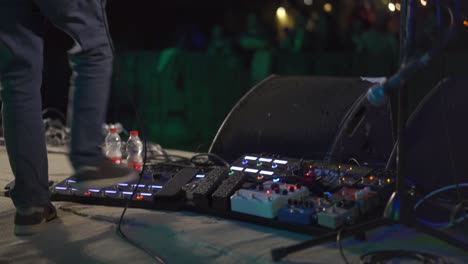 guitar player using pedals live on stage music show