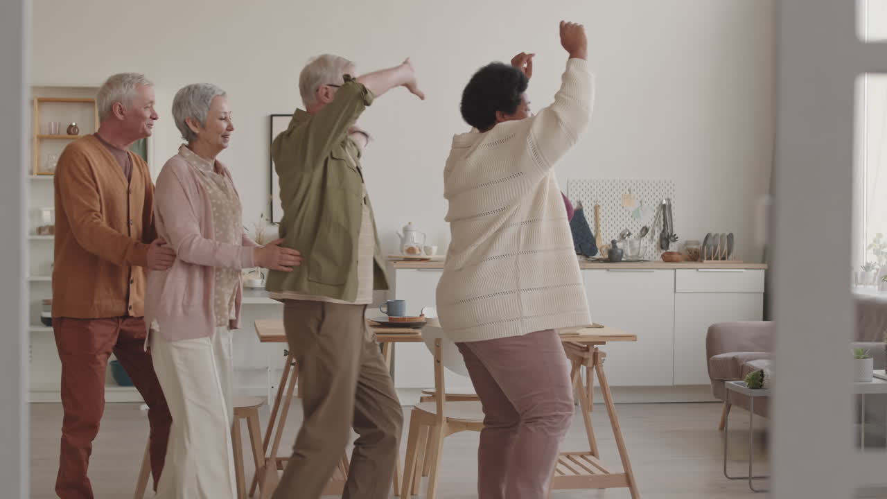 Joyful Senior Friends Dancing and Moving Together Indoors