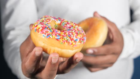 hand holding donuts