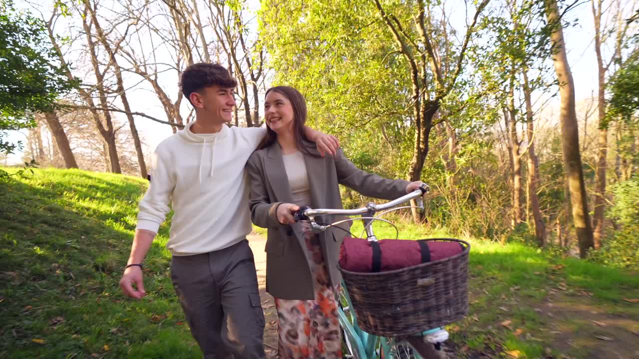 Couple Walking with Bike in Forest