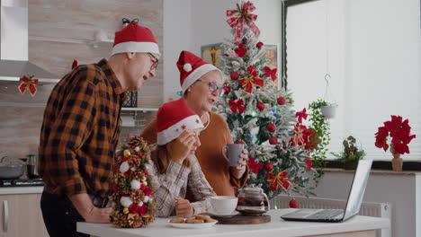 family talking with remote parents during online videocall meeting on laptop