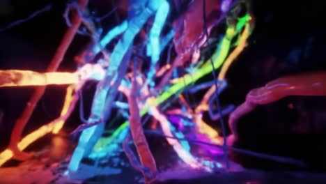 experience an immersive display of vivid colors and intricate light patterns as visitors explore a digital art installation in an urban gallery at night.