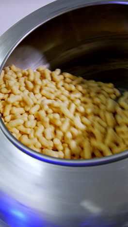 corn sticks factory making. corn snack factory flips. vertical video