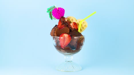 eating chocolate ice cream with metal spoon decorated with strawberries