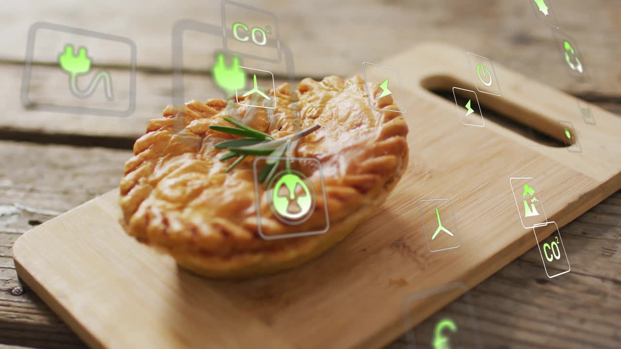 Eco-friendly icons floating around savory pie on wooden board, creating animation