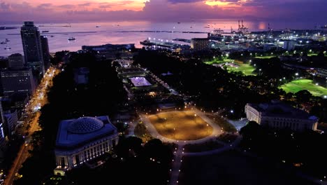 aerial view of rizal luneta park at night with lights on water fountain during beautiful sunset in capital city of manila philippines