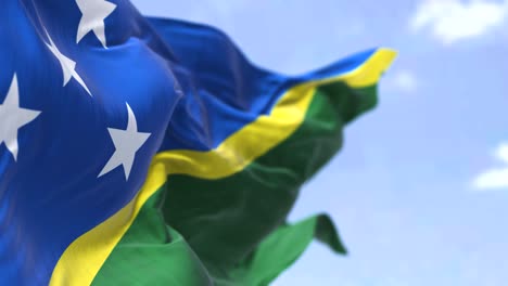 detail of the national flag of solomon islands waving in the wind on a clear day