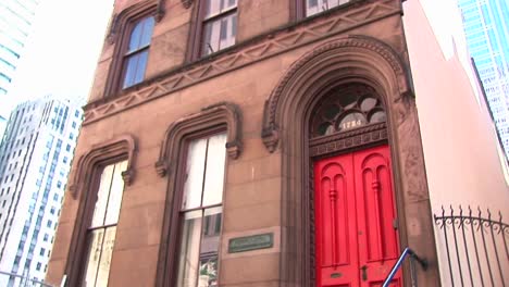 Camera-Pans-Up-A-Venerable-Old-Brownstone-Building-Now-Surrounded-By-Skyscrapers-In-A-Once-Residentialneighborhood