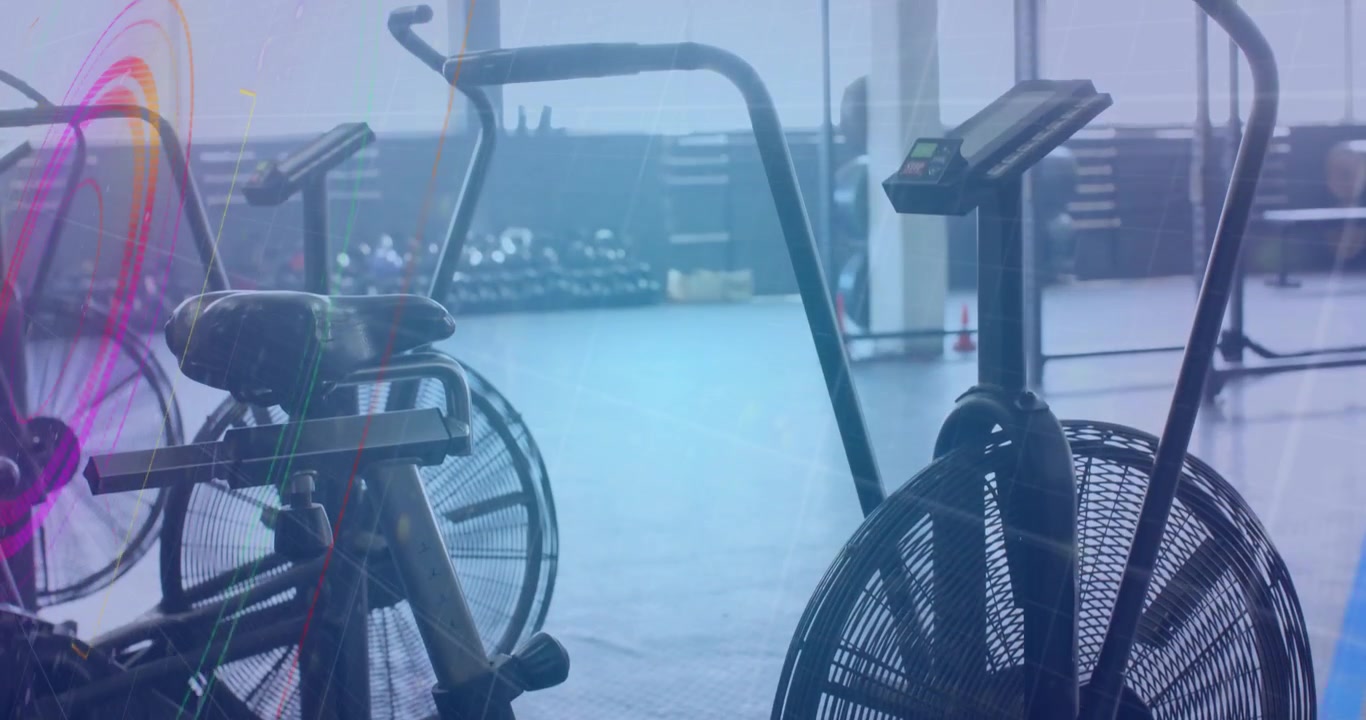 Neon overlay fading in over air bikes, rotating shifting hues dissolving to highlight workout gear