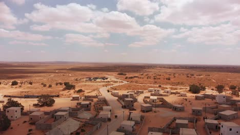 aerial-view-with-cmaera-goes-forward-of-big-building-in-palestine-near-Gaza-at-the-desert-showing-some-clouds-and-the-horizon