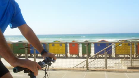 side view of active senior caucasian man checking time on smartwatch on a promenade at beach 4k