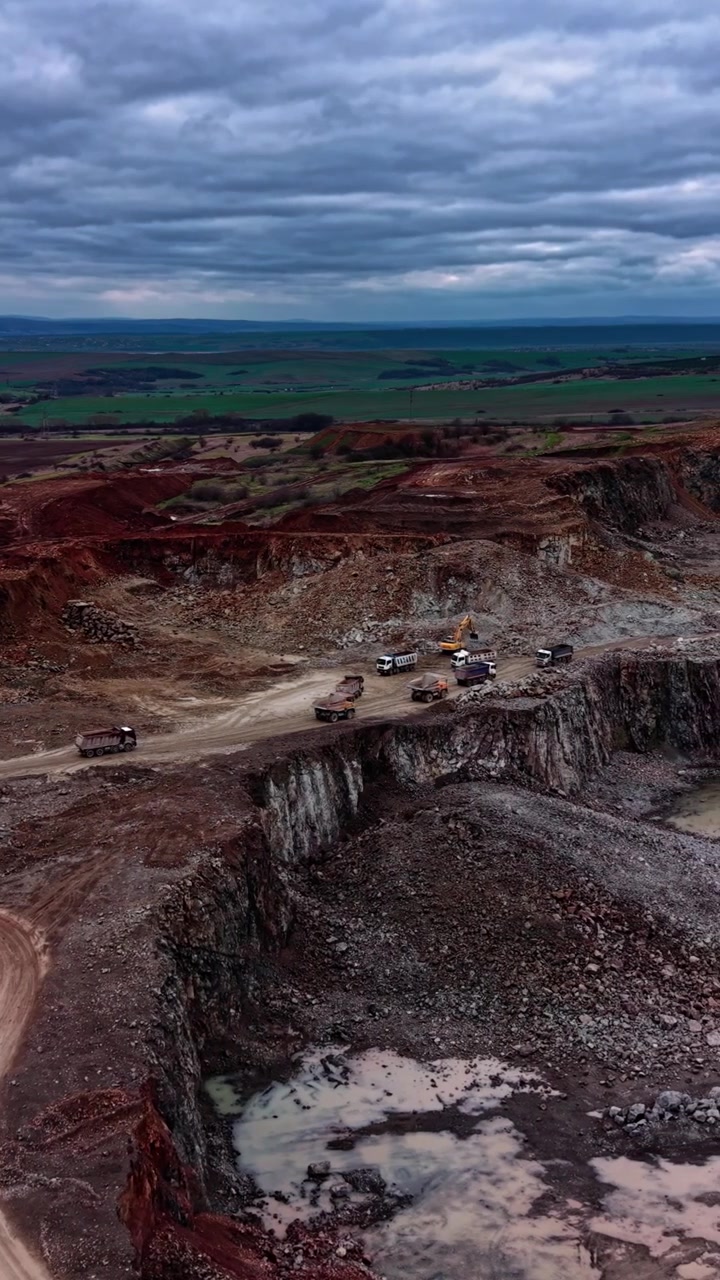 Aerial View of Heavy Machinery Working in an Open Pit Quarry