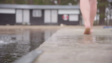 Closeup-female-ice-bathers-feet,-as-she-walks-away-down-the-pontoon