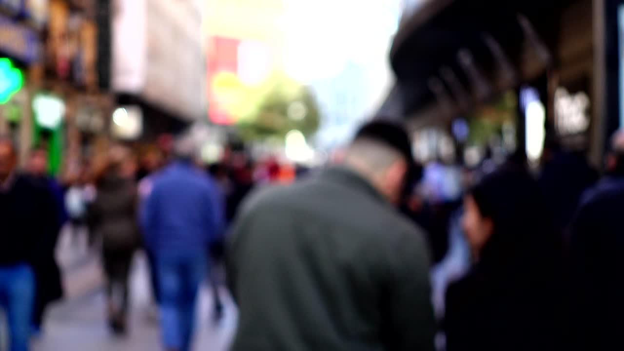 Unknown people on city street. Madrid. Out of focus.