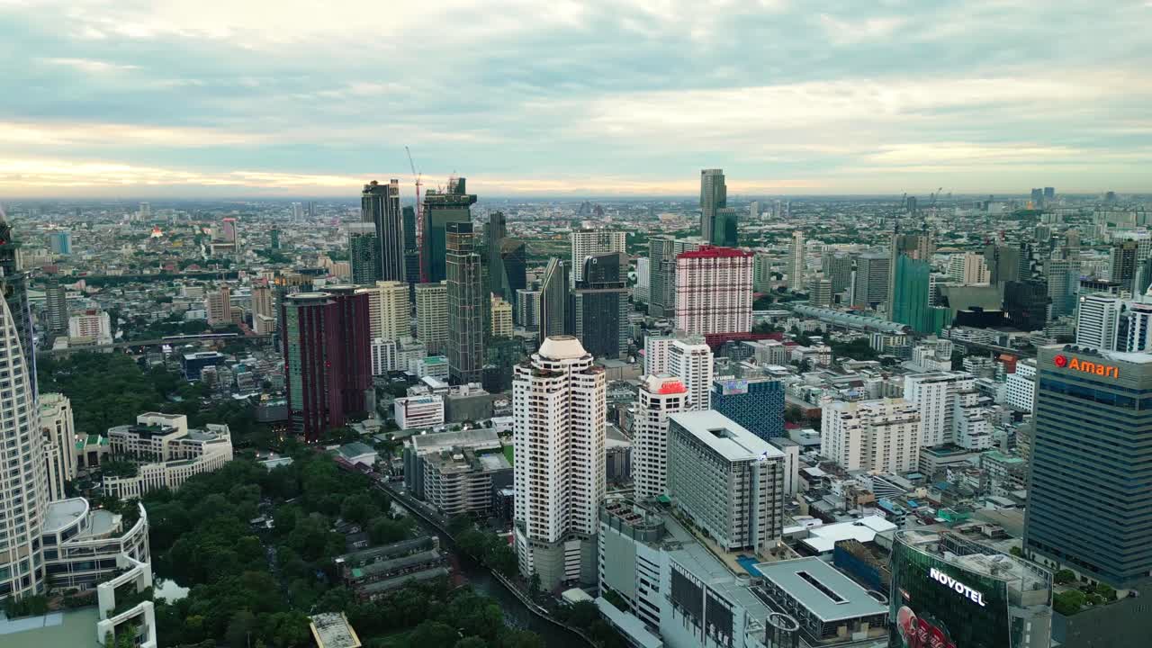 Business district aerial view of Sukhumvit road shopping mall and modern skyline at sunset smart city concept