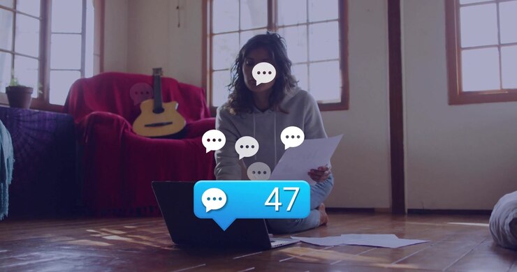 Woman managing call and reviewing document on laptop, tracking rising chat messages in tech demo
