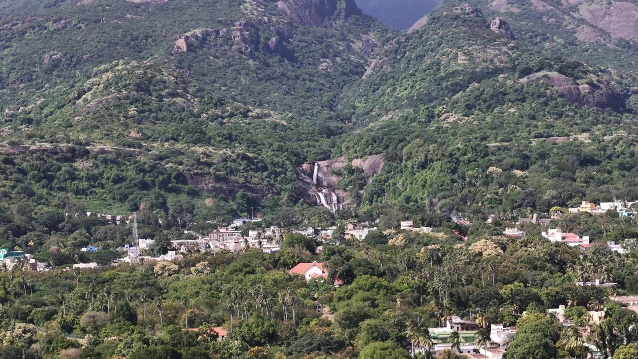 Courtallam waterfalls, Tamil nadu, the “Spa of South India,” captured from above — forested hills, gushing waterfalls, and vibrant town colors at the foot of the Western Ghats