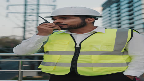construction worker using a walkie-talkie on a construction site