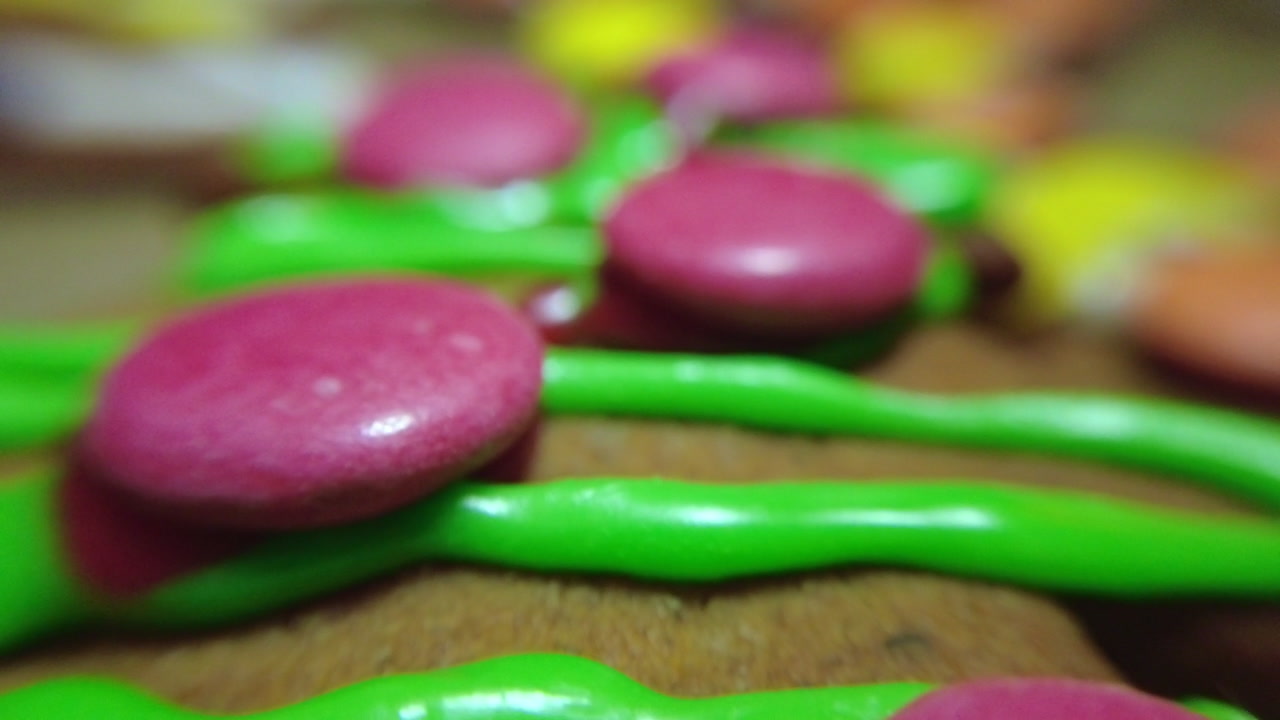 Gingerbread cookies with crystyr and colorful candies. Close-up macro footage. Home cooking Christmas concept.