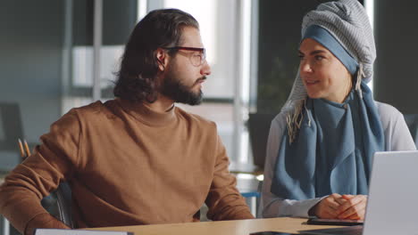 Portrait-of-Middle-Eastern-Man-and-Muslim-Woman-at-Work-in-Office