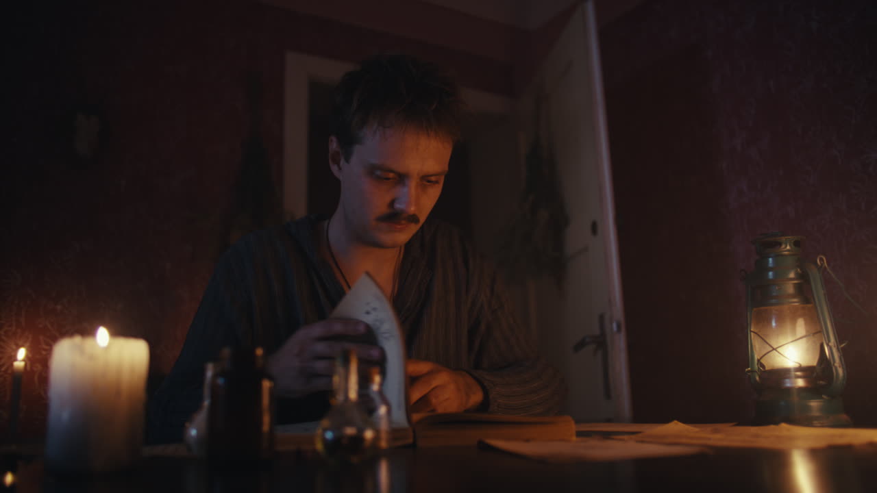 Man Studying by Candlelight in a Dimly Lit Vintage Room