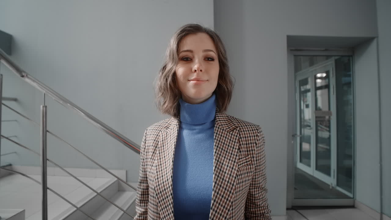 Woman Taking Selfie on Stairs in Office Building