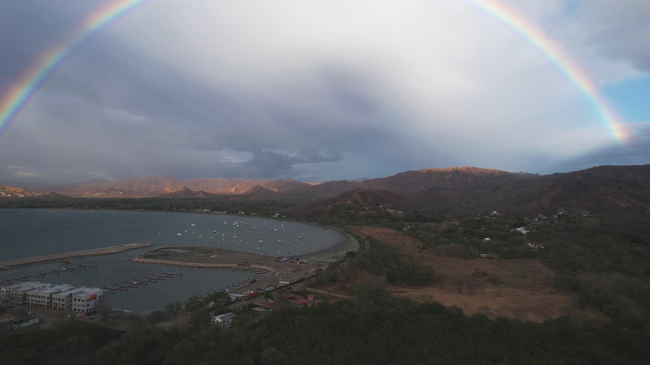 A beautiful round rainbow fills the frame over the sea